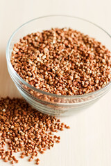 Raw buckwheat groats in a transparent glass plate
