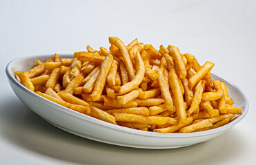 Portion of french fries served on plate on white background
