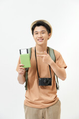 Young male traveler is excited about a new trip while holding his passport and some tickets.