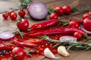 Fototapeta na wymiar spices onion red pepper garlic on wood board