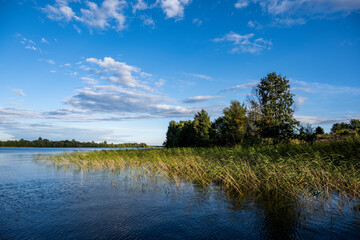 Fototapeta na wymiar view of a large beautiful lake against the backdrop of clouds and blue sky