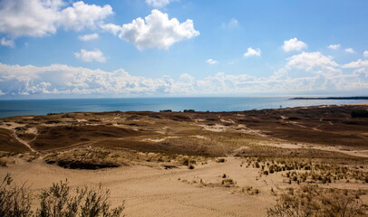 Dunes against the backdrop of the lagoon and the sky