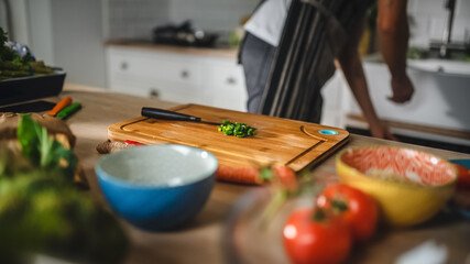Close Up Shot of a Chopped a Green Spring Onion on a Cutting Board. Healthy Organic Salad Meal in a Modern Kitchen. Natural Clean Diet and Healthy Way of Life Concept.