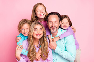 Photo of positive idyllic big family enjoy spend weekend together daddy piggyback younger daughter mommy hug her siblings offspring isolated over pastel color background