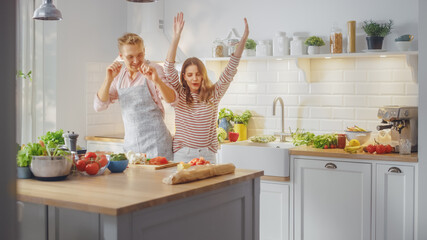 Handsome Young Man in Pink Shirt and Apron and Beautiful Girl in Striped Jumper are Creatively...