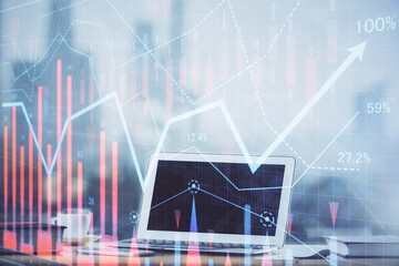 Forex graph hologram on table with computer background. Multi exposure. Concept of financial markets.