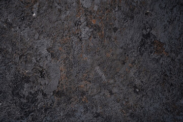 The black texture of the concrete wall is a rough shape. The old stone floor grunge