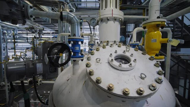 Refinery factory inside. Equipment, steel tanks and boilers for chemical mixing