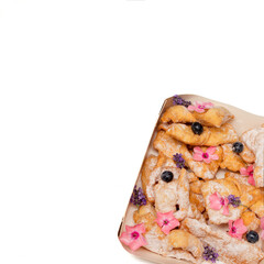 Crunchy brittle thin straws twigs cookies sprinkled with powdered sugar decorated berry flowers. Homemade baking. Concept of bakery, aesthetic food serving. Sweet life. Close-up Photo. Copy space