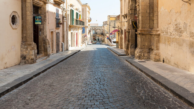 NOTO, ITALY - JULY 3, 2011: street via Rocco Pirri in Noto city in Sicily. In 2002 Noto and its church were declared a UNESCO World Heritage Site for sicilian baroque architecture.