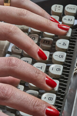 Hands of a secretary with typewriter on white background