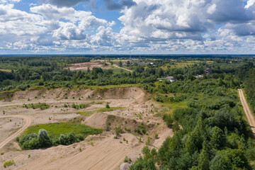 Fototapeta na wymiar Aerial view of old gravel quarry and cloudy sky