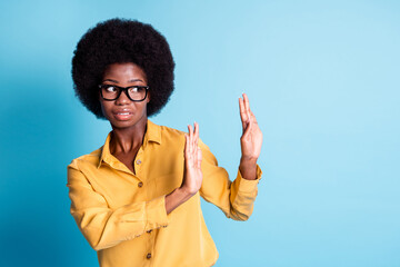 Photo of dark skin big volume hairstyle woman raise palms look empty space showing stop ecologist...