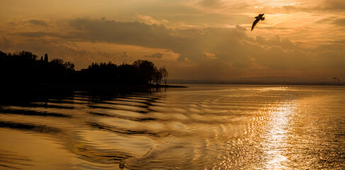 Golden sunset light over Lake Trasimeno and Isola Maggiore (Greater Island) in Umbria