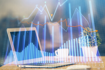 Financial graph colorful drawing and table with computer on background. Double exposure. Concept of international markets.