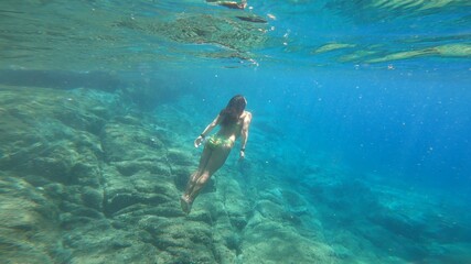 young woman snorkelling in costa brava