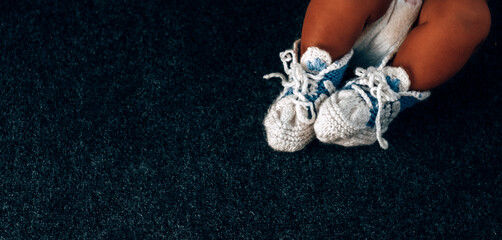 baby feet in knitted blue socks close-up