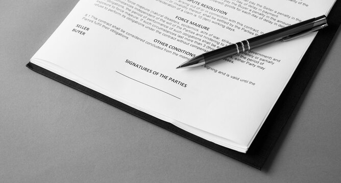 Signature and pen on business contact. black and white image