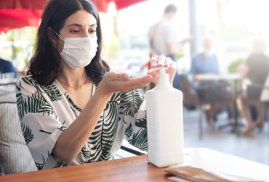 woman washing hand in cafe using disinfectant. Hygiene first
