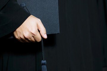 graduates ,close up student holding hats and tassel black in hand during commencement success of the university, Concept education congratulation.Graduation Ceremony.