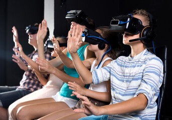 Boy is enjoying movie in virtual reality glasses indoors.