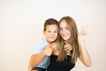 Two smiling brothers with thumb up on white background