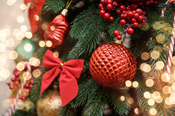 Christmas or New Year Holiday Festive background. Closeup of Christmas tree decorations with sparkles
