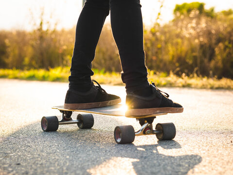 A shallow focus shot of a young male riding a skateboard