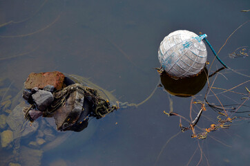 Old dirty buoy on the water