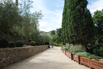 The beautiful backyard with ancient stone architecture and the blossoming garden of the medieval christian abbey in the mountain valley of Pyrenees in France