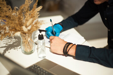young man working in gloves in a laptop