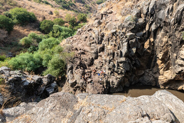 A small  reservoir between rocks on the shallow mountain river Jelabun with crystal clear water in the Golan Heights in northern Israel
