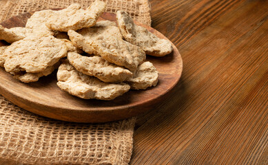 Raw Dehydrated Soy Meat or Soya Chunks on Wood Background
