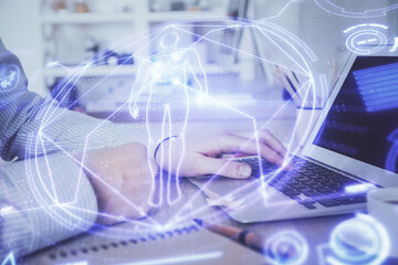 Science hologram with man working on computer on background. Concept of study. Double exposure.