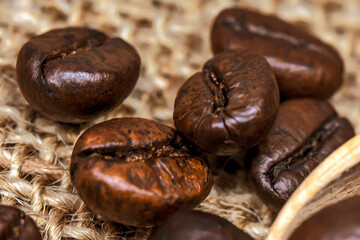 Obraz premium Coffee beans. Macro photo Burlap fabric. Rough fabric texture. Fabric Canvas. Coffee beans on sacking. Coffee abstraction.