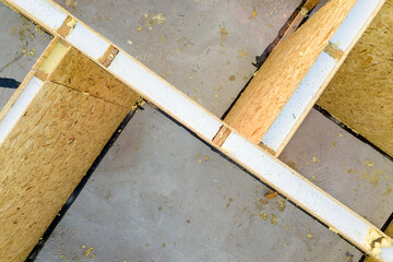 Obraz premium Construction of new and modern modular house. Walls made from composite wooden sip panels with styrofoam insulation inside. Building new frame of energy efficient home concept.