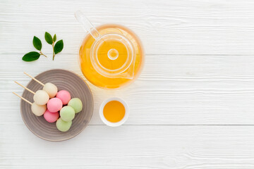 Japanese tea and sweet dumplings Dango on plate, top view