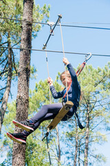 pretty young girl in a tree climbing park