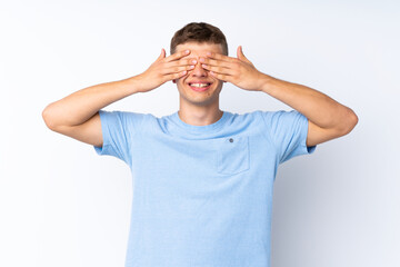 Young handsome man over isolated white background covering eyes by hands