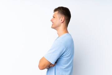 Young handsome man over isolated white background in lateral position