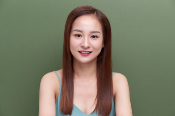 Beautiful woman face close up portrait young studio on green