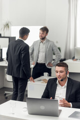 Telephone conversations with the customer of the company's Internet and it support service. Employee in the office.