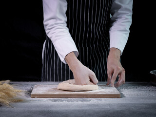 Hands preparing bread dough, kneading the dough. Hands with flour splash, food homemade bakery concept