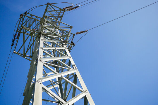 High voltage pole on blue sky background