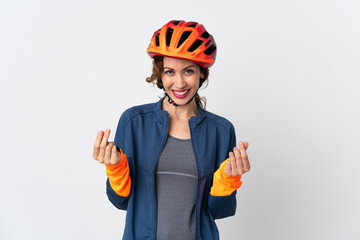 Young cyclist woman isolated on white background making money gesture