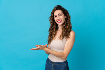 Young caucasian woman isolated on blue background applauding