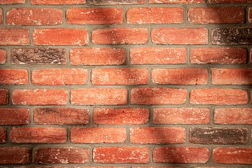 Fototapeta premium Shadow and light from a window on a red brick wall
