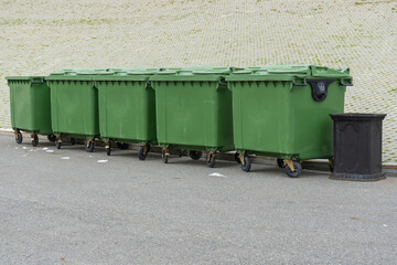 Green plastic garbage containers installed along in the Park. The concept of separate garbage...