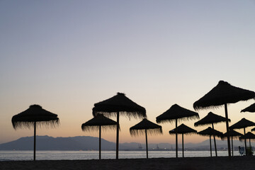 beach umbrellas in the sunset