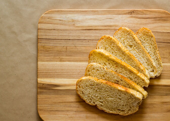 Sliced bread on cutting board. Flat lay view.